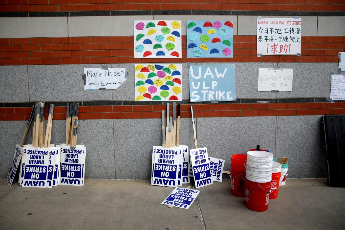 Picket signs are propped against a wall at UCLA during the academic workers' strike.