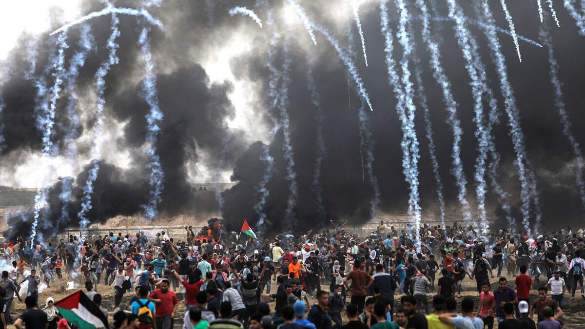 Israeli army forces fire tear gas at Palestinian protesters in the Gaza Strip during clashes at the border fence on May 4, 2018.