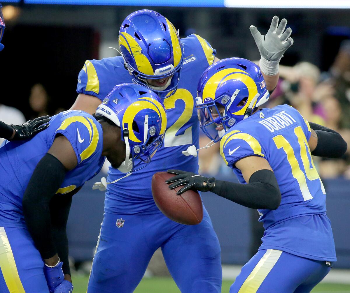 The Rams' Cobie Durant (14) celebrates after returning an interception for a touchdown against the Broncos. 