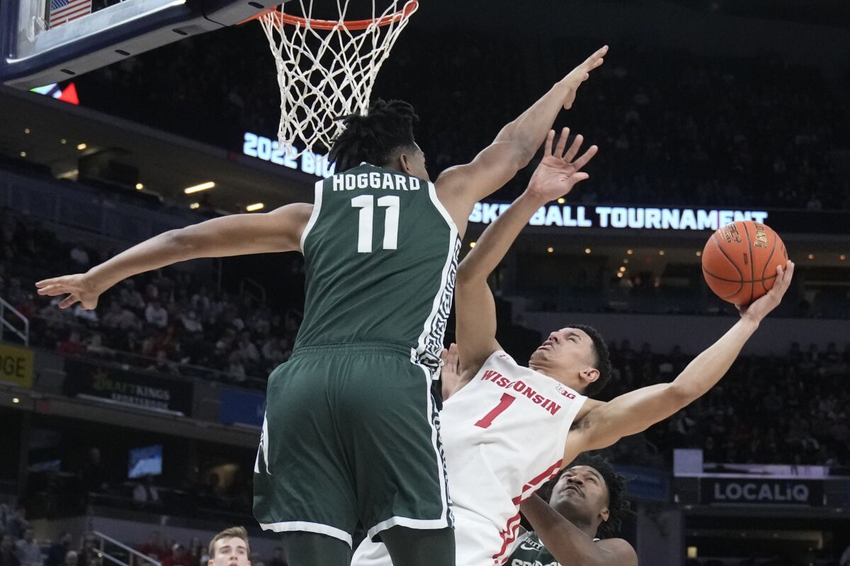 Wisconsin's Johnny Davis (1) shoots over Michigan State's A.J. Hoggard (11) during the first half of an NCAA college basketball game at the Big Ten Conference tournament, Friday, March 11, 2022, in Indianapolis. (AP Photo/Darron Cummings)