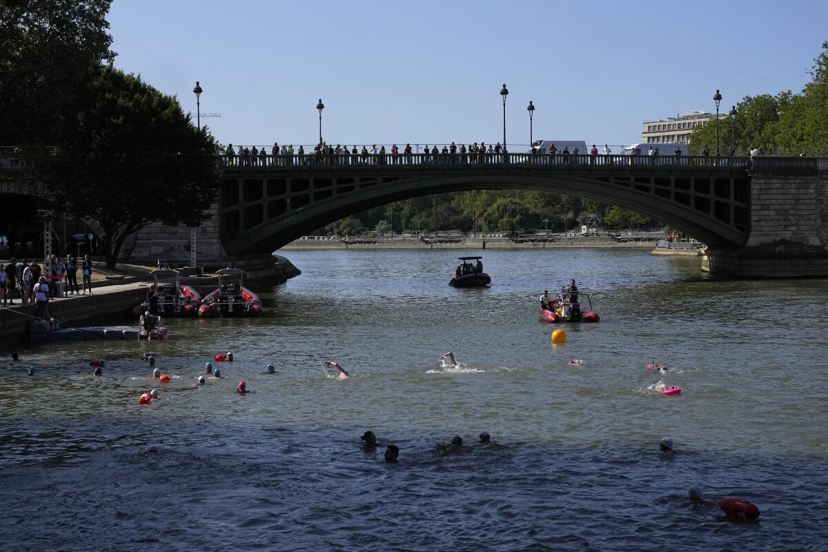 People swim in the Seine River in Paris on July 17.