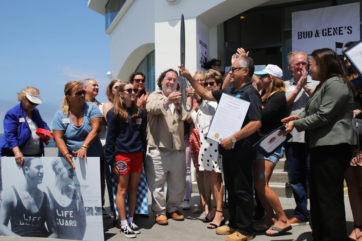 Alex Leff, owner of Bud & Gene's restaurant, center, with Huntington Beach Mayor Barbara Delgleize at grand opening.