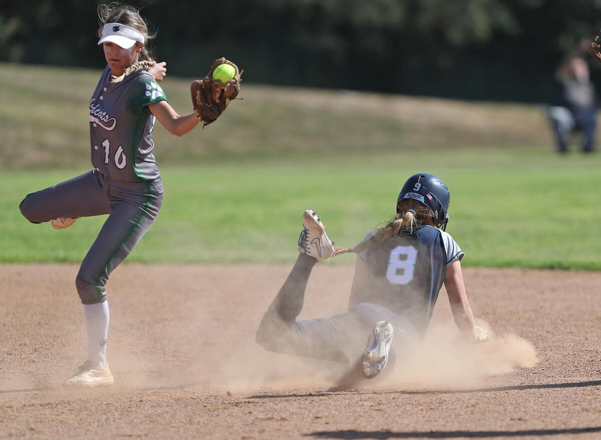 Newport Harbor's Olivia Williams (8) slides into second safely under the tag of Twentynine Palms' Hailee Jenkins (10) .
