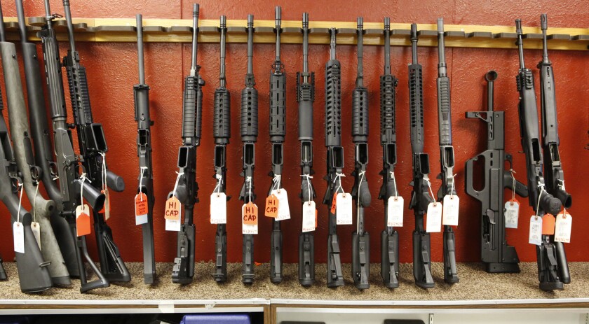 Rifles sit on display and for sale at a gun store in Aurora, Colo., in 2013.