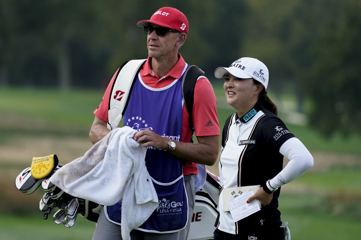 Jin Young Ko, of South Korea, right, smiles after finishing the first round of the Cognizant Founders Cup LPGA golf tournament, Thursday, Oct. 7, 2021, in West Caldwell, N.J. (AP Photo/John Minchillo)