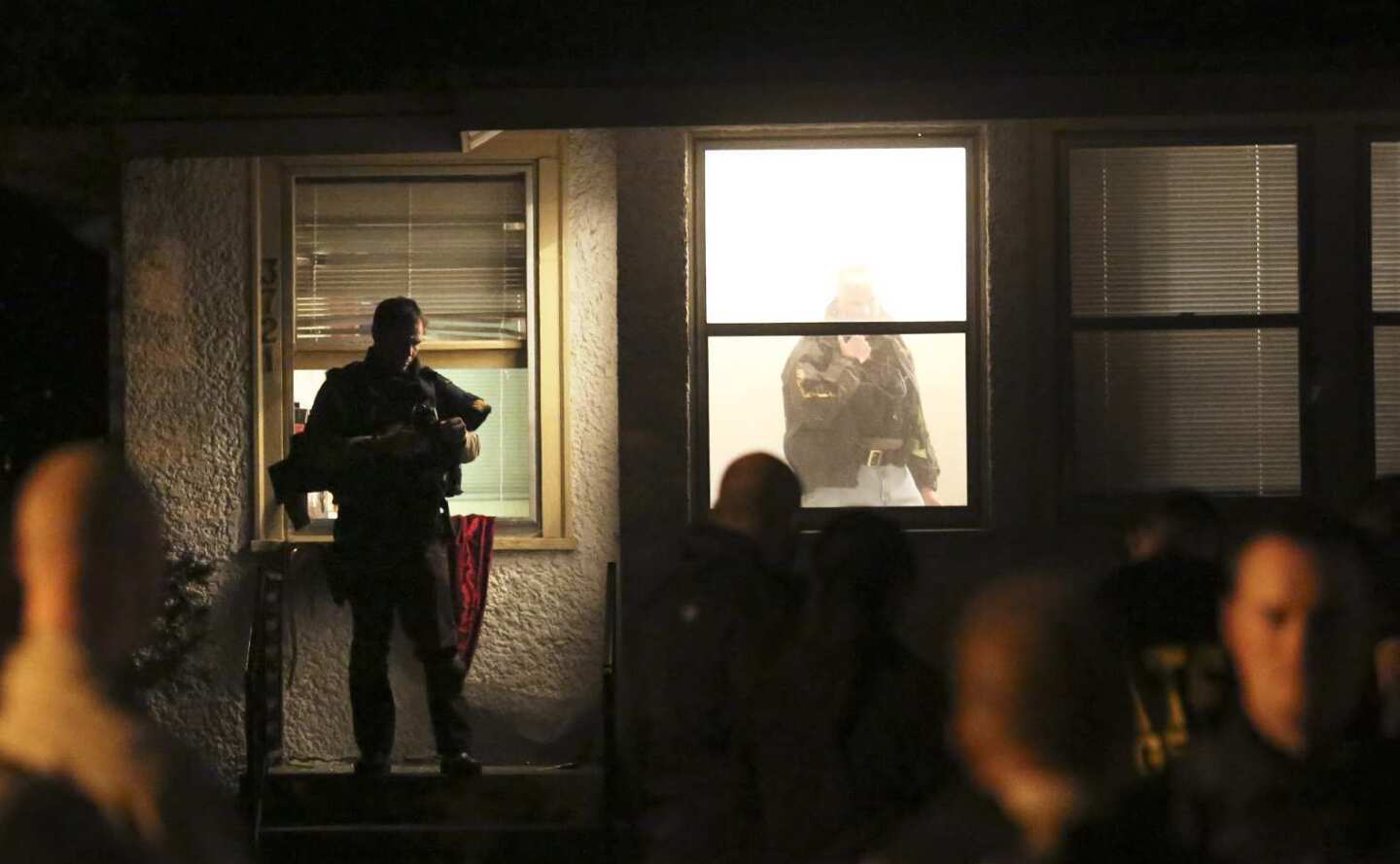 The sheriff's department along with AFT officials search the home of a suspect in the shooting of several people in a sign shop in Minneapolis on Thursday. Authorities say a gunman killed four people inside a Minneapolis sign-making business before turning the weapon on himself. Officers summoned Thursday afternoon by a 911 call discovered the victims' bodies shortly after arriving at Accent Signage Systems Inc. on the city's north side, police say. Police spokesman Sgt. Stephen McCarty said the gunman also injured four people in the attack.