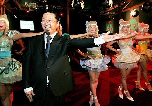 Takashi Murakami poses with a few Miss Ko girls at the Geffen Contemporary at MOCA for the Murakami Gala on Oct. 28.