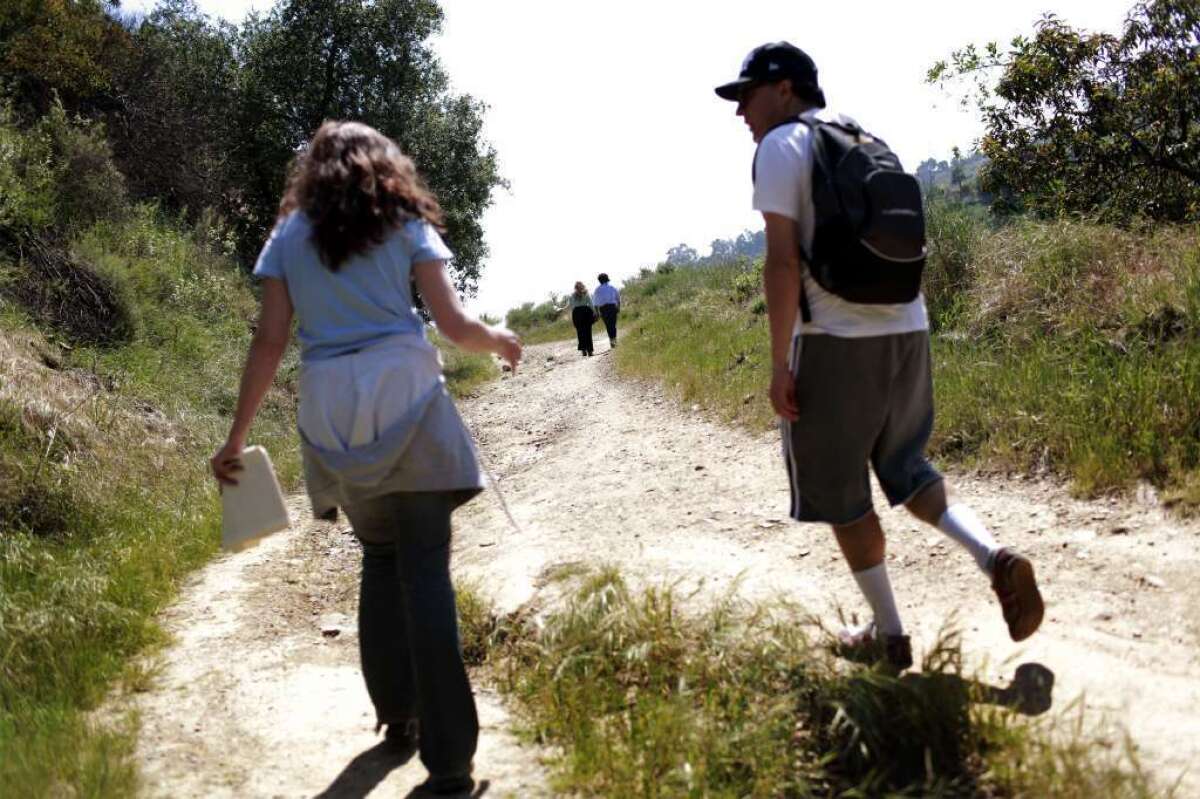 Ellen Scott, left and John Mirisch, walk up Hastain trail in L.A.'s Franklin Canyon Park. Scott has led others in protesting development that would prevent hikers from enjoying the trail.