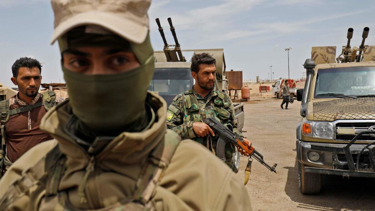 Members of the Syrian Democratic Forces fighting the Islamic State extremist group advance near Abu Kamal in eastern Syria on Tuesday.