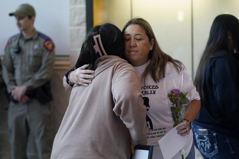 Parents, students and families arrive for a meeting of the Board of Trustees of Uvalde Consolidated Independent School District for a termination hearing to decide the employment fate of Uvalde School District Police Chief Pete Arredondo Wednesday, Aug. 24, 2022, in Uvalde, Texas. (AP Photo/Eric Gay)