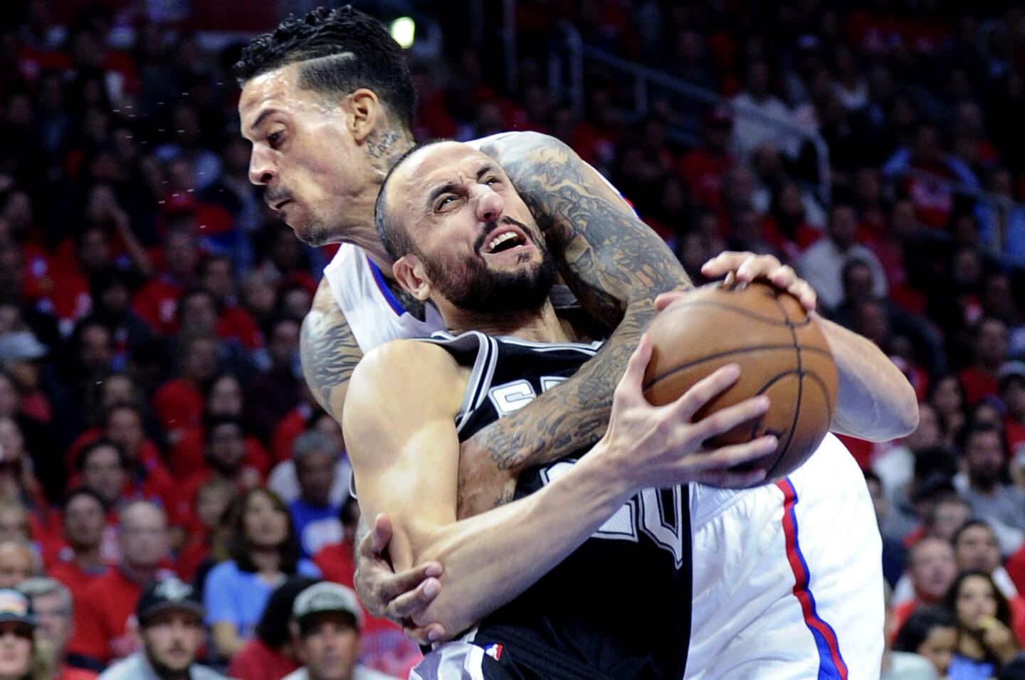 Clippers forward Matt Barnes fouls Spurs guard Manu Ginobili as Ginobili drives to the basket in the first half.