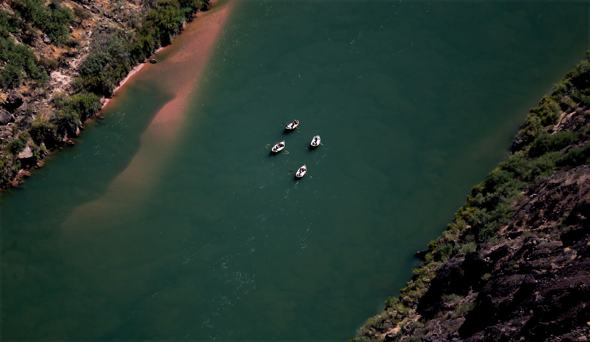 Four white rafts seen from high overhead.