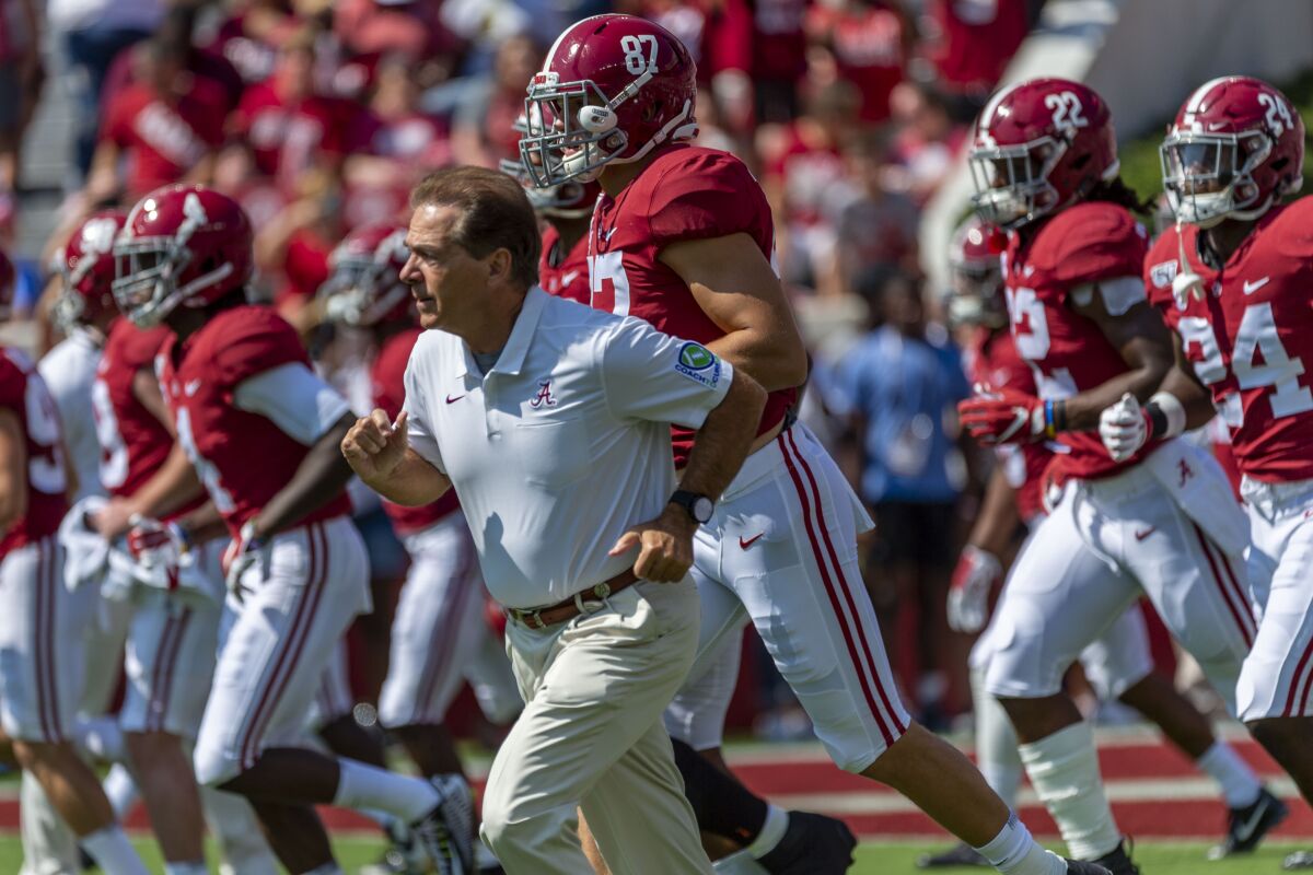 Alabama coach Nick Saban leads the team onto the field before a game against Mississippi.