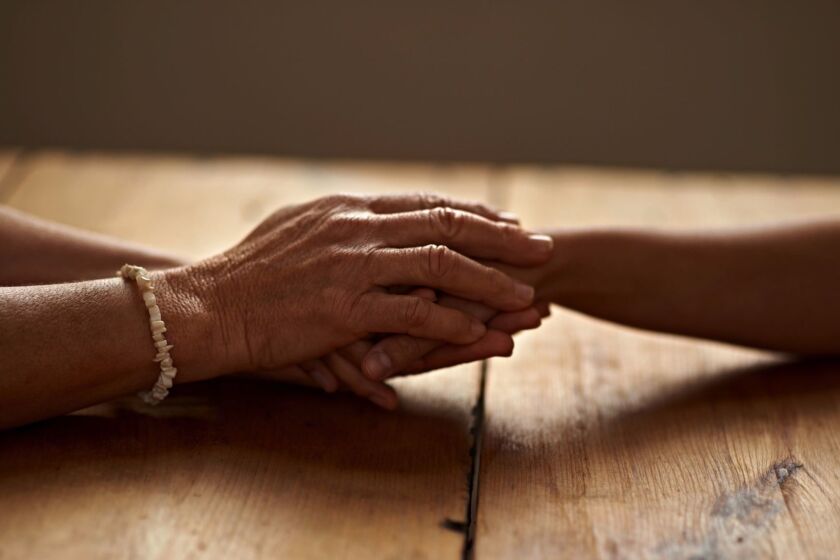 A cropped shot of a woman holding a loved one's hand in supporthttp://195.154.178.81/DATA/i_collage/pi/shoots/783366.jpg