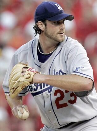 Los Angeles Dodgers starting pitcher Derek Lowe delivers a pitch in the first inning against the St. Louis Cardinals.