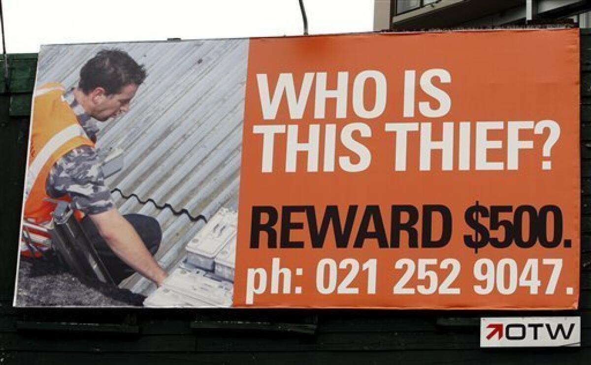A billboard on the corner of a major road intersection in downtown Auckland, New Zealand, Monday, Nov. 24, 2008. A thief who stole expensive fittings from a billboard in New Zealand's largest city has become the subject of giant "Wanted" posters after the company that owns them obtained a photograph of the crime. The unidentified thief was photographed by a suspicious onlooker as he uncoupled 15 expensive electrical transformers that boost the lighting of a billboard in Auckland in October. (AP Photo/New Zealand Herald, Brett Phibbs)