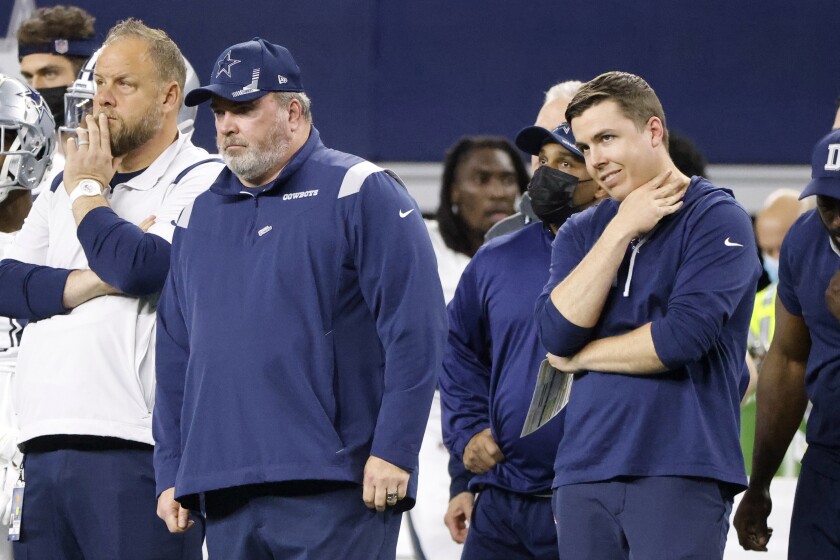 Dallas Cowboys offensive coordinator Kellen Moore, right, and coach Mike McCarthy watch from the sideline during the second half of an NFL football game against the Arizona Cardinals, Sunday, Jan. 2, 2022, in Arlington, Texas. (AP Photo/Michael Ainsworth)