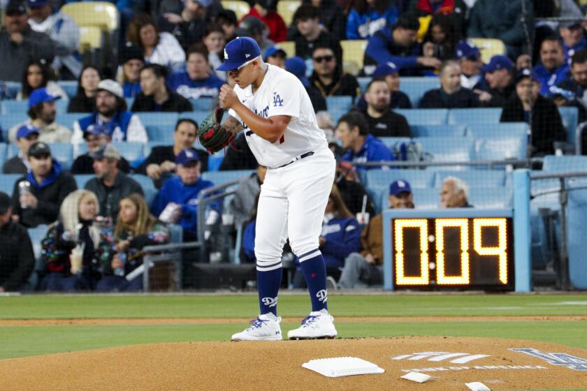 LOS ANGELES, CA - MARCH 30: Los Angeles Dodgers starting pitcher Julio Urias (7) prepares to pitch.