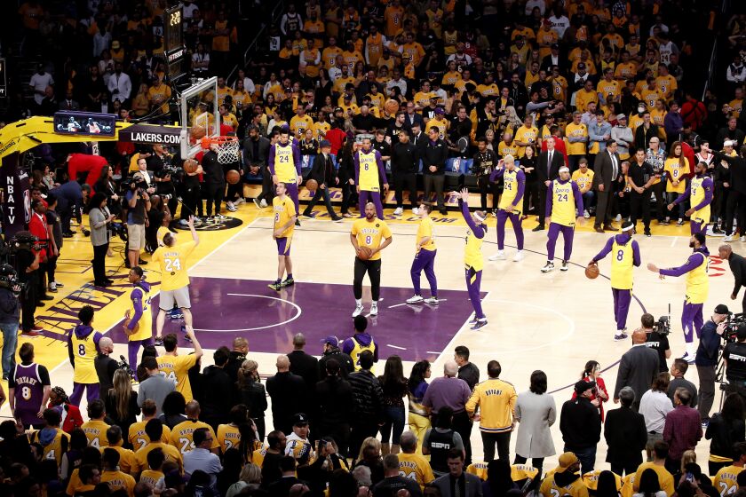 Los Angeles Lakers players wearing No. 24 and No. 8 jerseys in remembrance of the late Kobe Bryant prior to an NBA game against the Portland Trail Blazers at Staples Center Friday, Jan. 31, 2020, in Los Angeles. Bryant, the 18-time NBA All-Star who won five championships and became one of the greatest basketball players of his generation during a 20-year career with the Los Angeles Lakers, died in a helicopter crash Sunday. (AP Photo/Ringo H.W. Chiu)
