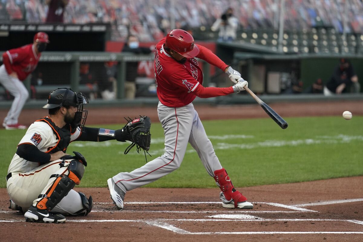 Angels third baseman Anthony Rendon hits a run-scoring single in front of Giants catcher Joey Bart.