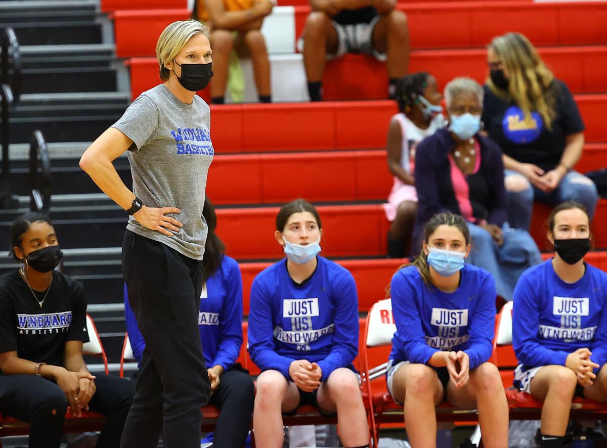 Vanessa Nygaard stands next to her Windward basketball team.