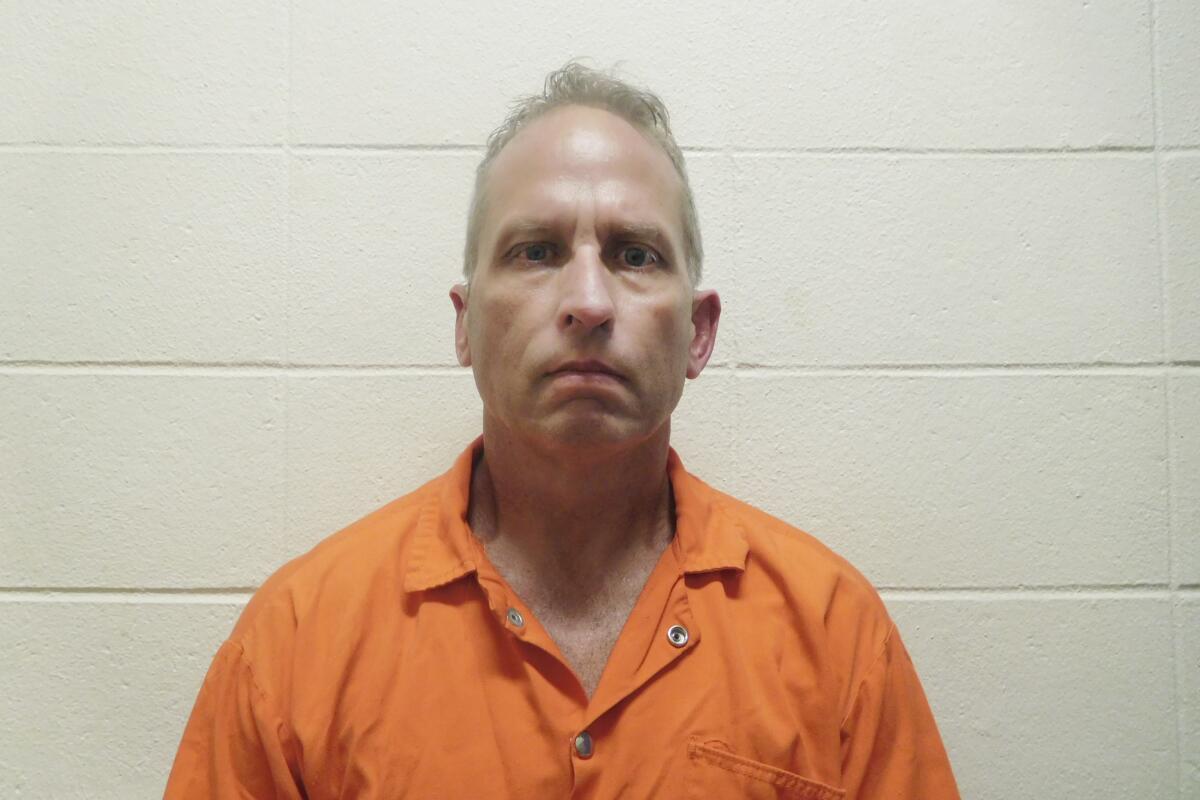 This booking image provided by the St. Charles, La., Parish Sheriff’s Office shows Chad Scott, a prolific narcotics agent known as the “white devil” among drug traffickers. Scott was sentenced Thursday, Aug. 12, 2021, to more than 13 years behind bars for stealing money from suspects, falsifying government records and committing perjury during a federal trial. The sentencing capped a five-year case that shook the DEA and resulted in convictions of three other members of a New Orleans-based federal drug task force. ( St. Charles Parish Sheriff’s Office via AP)