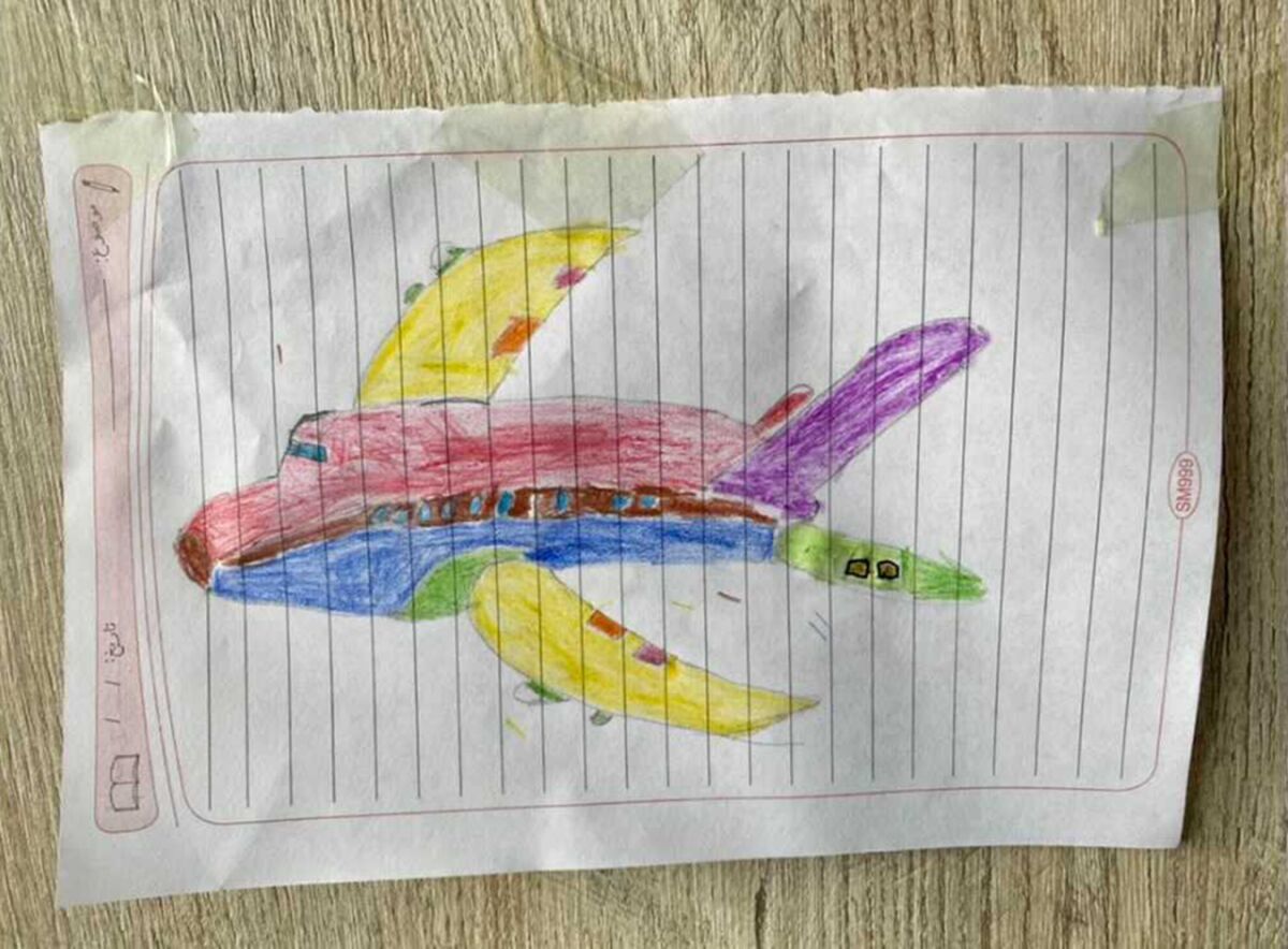 A child's drawing of a colorful airplane