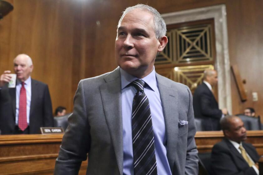 Environmental Protection Agency Administrator Scott Pruitt arrives to testify before the Senate Environment Committee on Capitol Hill in Washington, Tuesday, Jan. 30, 2018. Committee member Sen. Ben Cardin, D-Md., is on the left. (AP Photo/Pablo Martinez Monsivais)