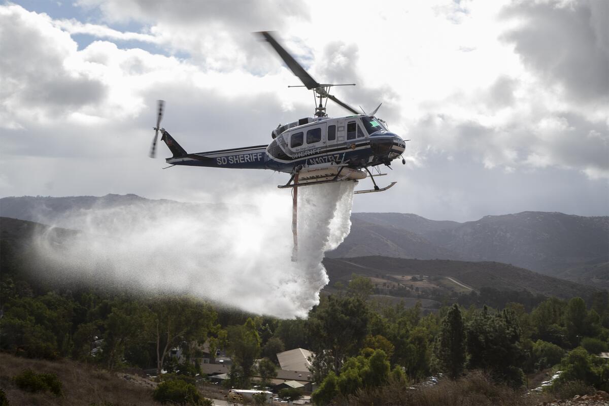 A San Diego County Sheriff's Department firefighting helicopter demonstrates a water drop