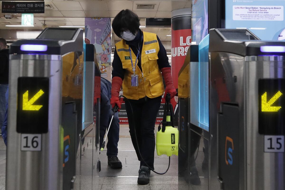 A worker sprays disinfectant as a precaution against the new coronavirus at a Seoul subway station on Wednesday.