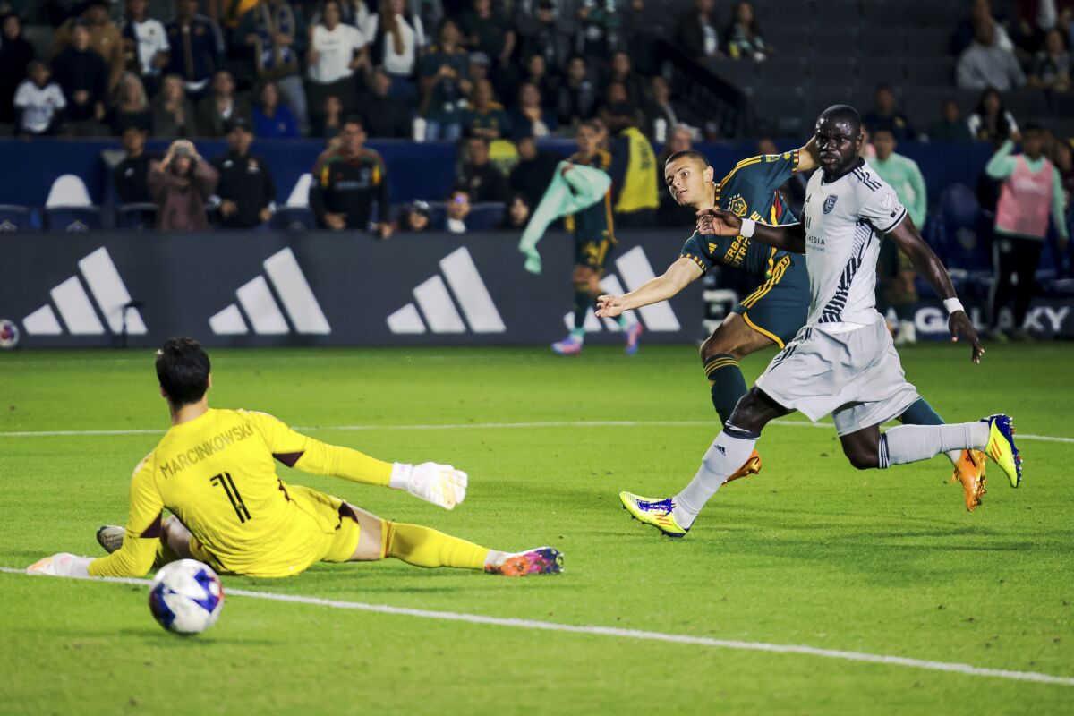 Galaxy forward Dejan Joveljic scores past San Jose Earthquakes goalkeeper JT Marcinkowski.