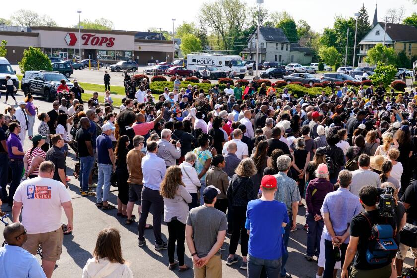 People gather outside the scene of a shooting at a supermarket in Buffalo, N.Y., Sunday, May 15, 2022. (AP Photo/Matt Rourke)