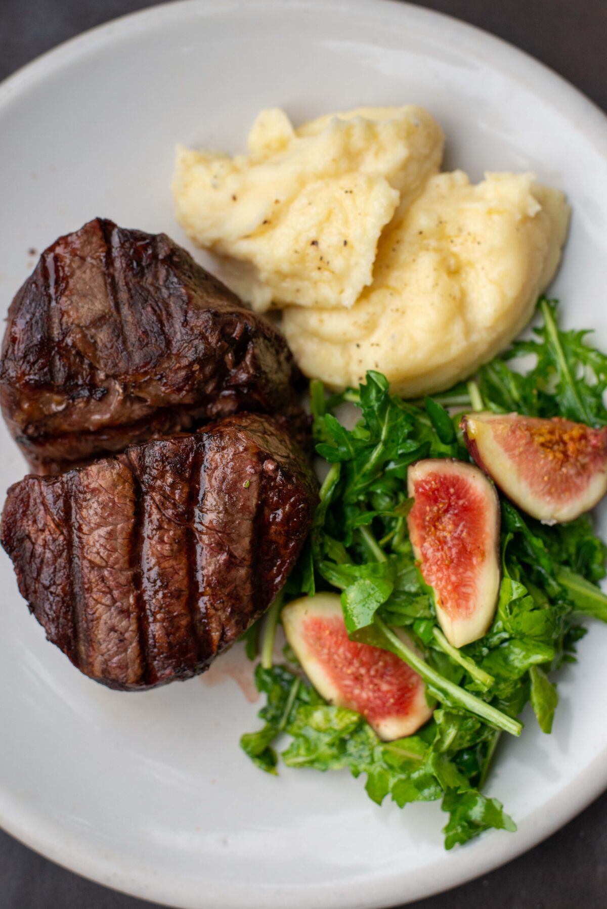 A steak filet, salad and potatoes are seen at a plat from the Don Julio steakhouse in Palermo.