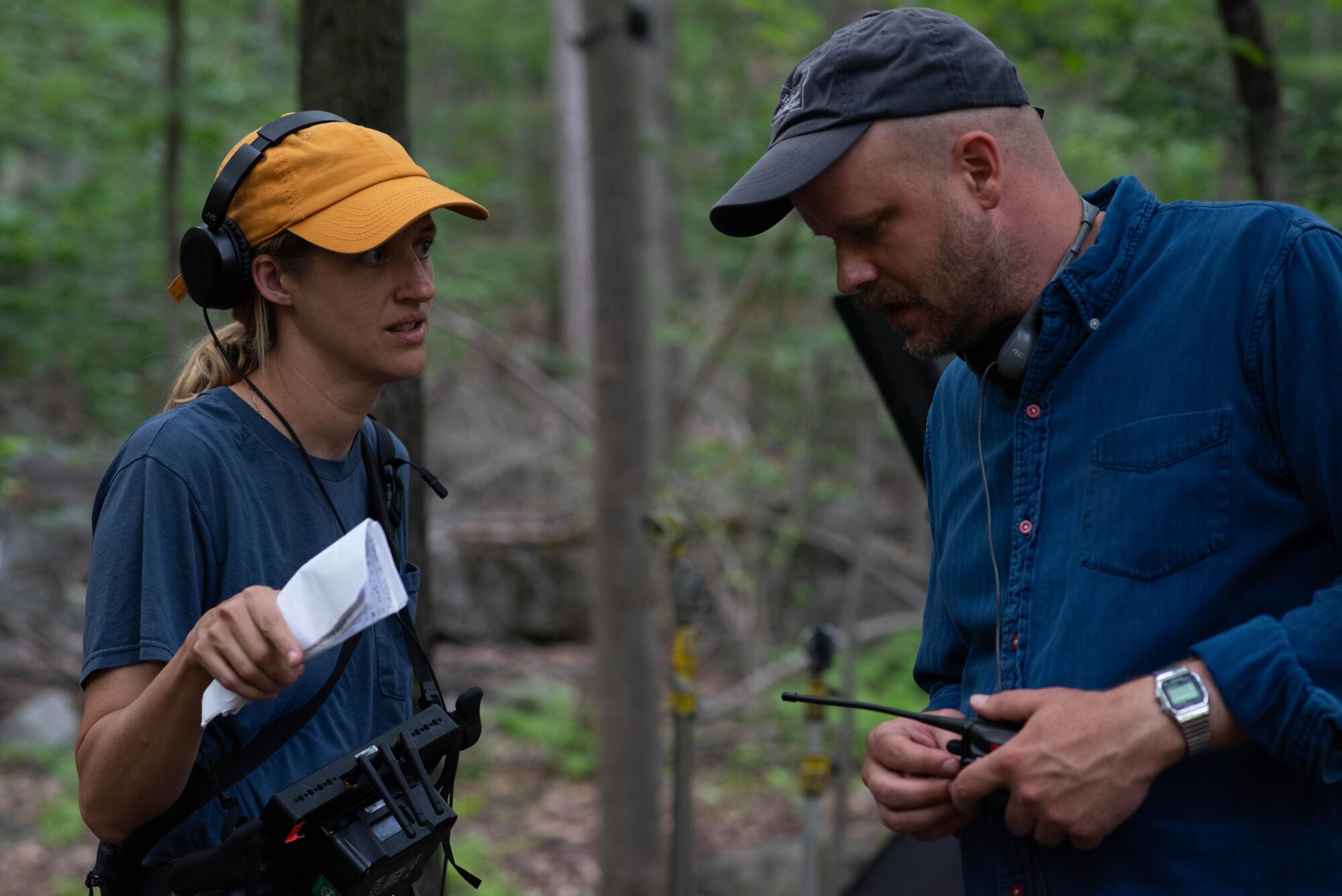 A director confers with her producer about an outdoor shoot.