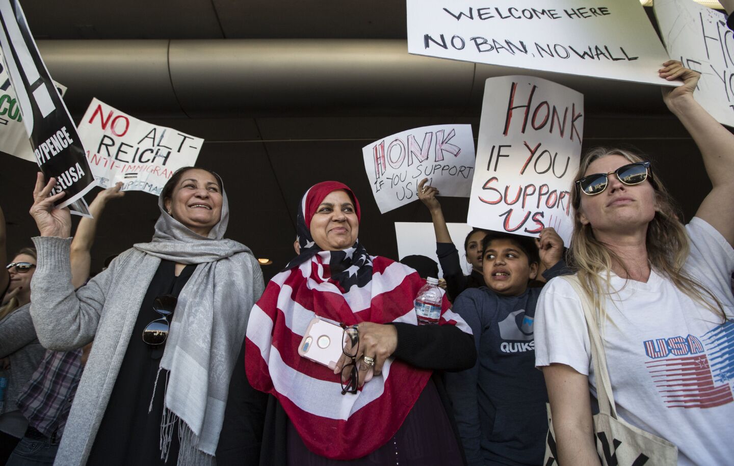 People gather at the Tom Bradley International Terminal to protest President Trump's immigration order.
