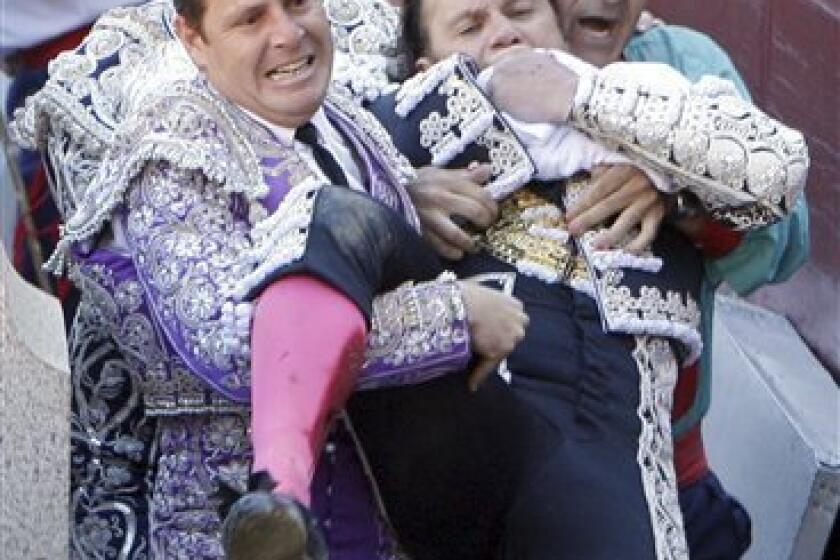 In this photo made Friday, May 21, 2010, Spanish matador Julio Aparicio is carried to infirmary after being gored by a bull during a bullfight during the San Isidro Feria at the Las Ventas bullring in Madrid. Aparicio underwent surgery and is out of critical danger. (AP Photo/Domingo Botan)