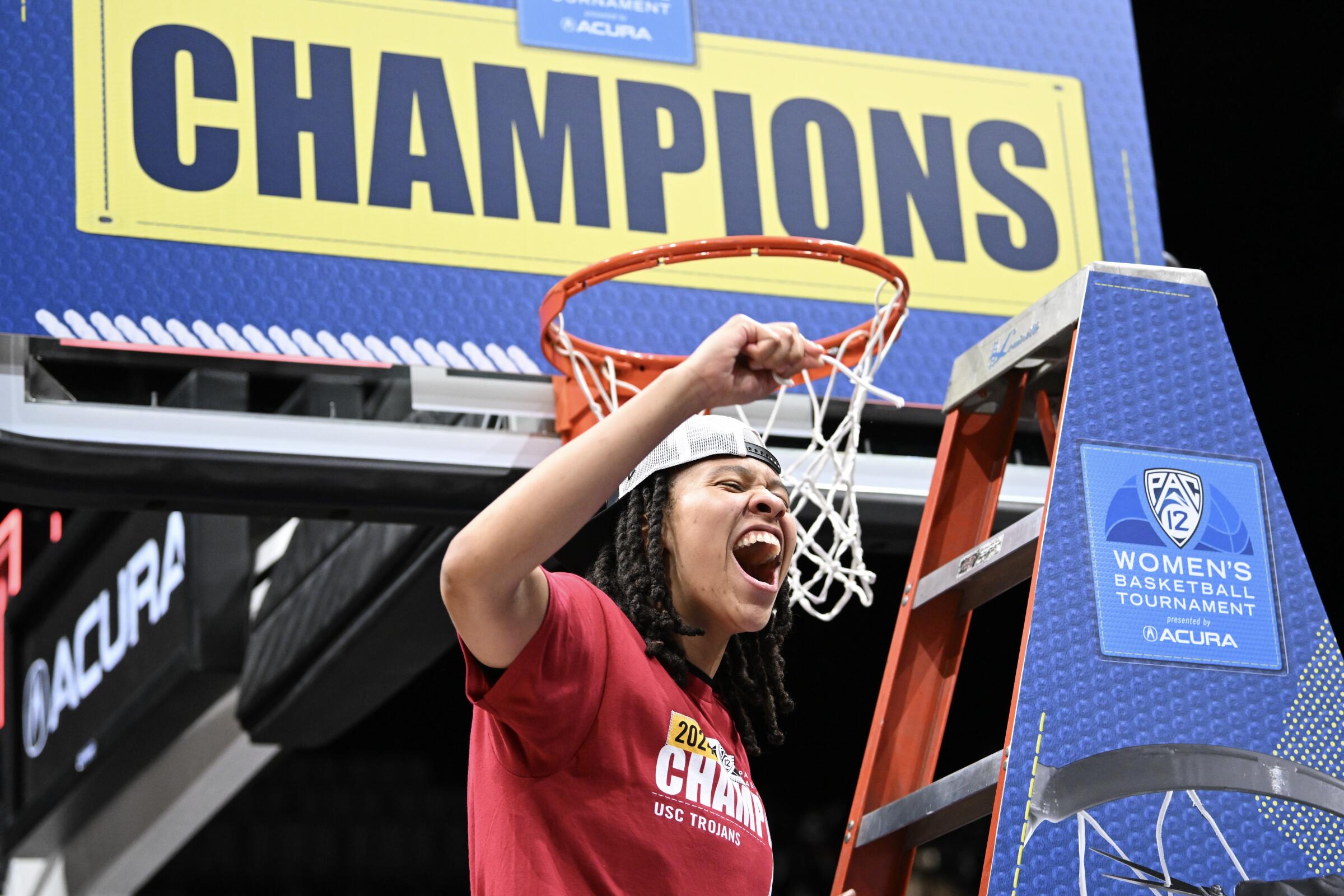 USC's McKenzie Forbes celebrates as she cuts a piece of a net after the Trojans' victory over top-seeded Stanford.