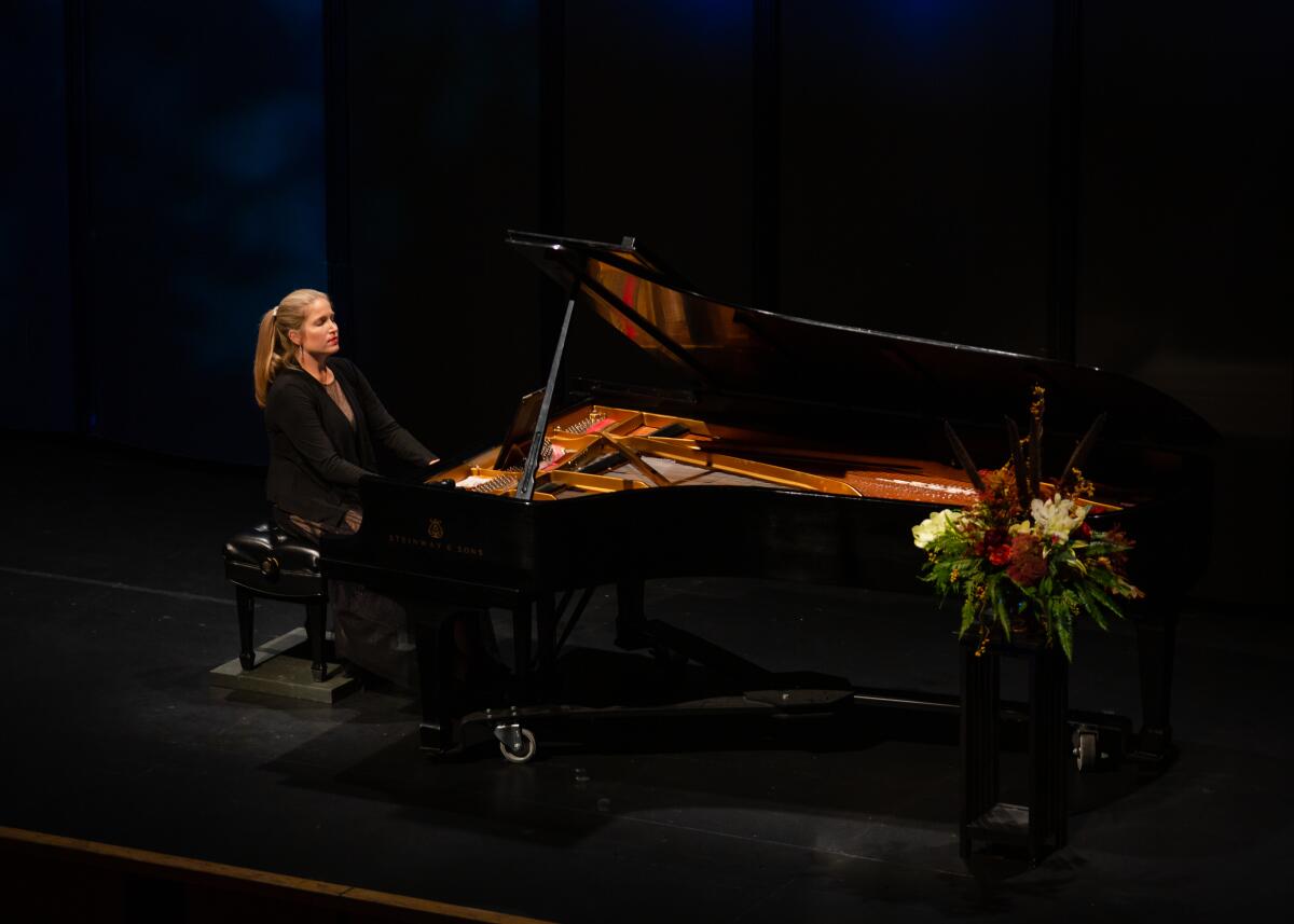 A woman plays the piano.