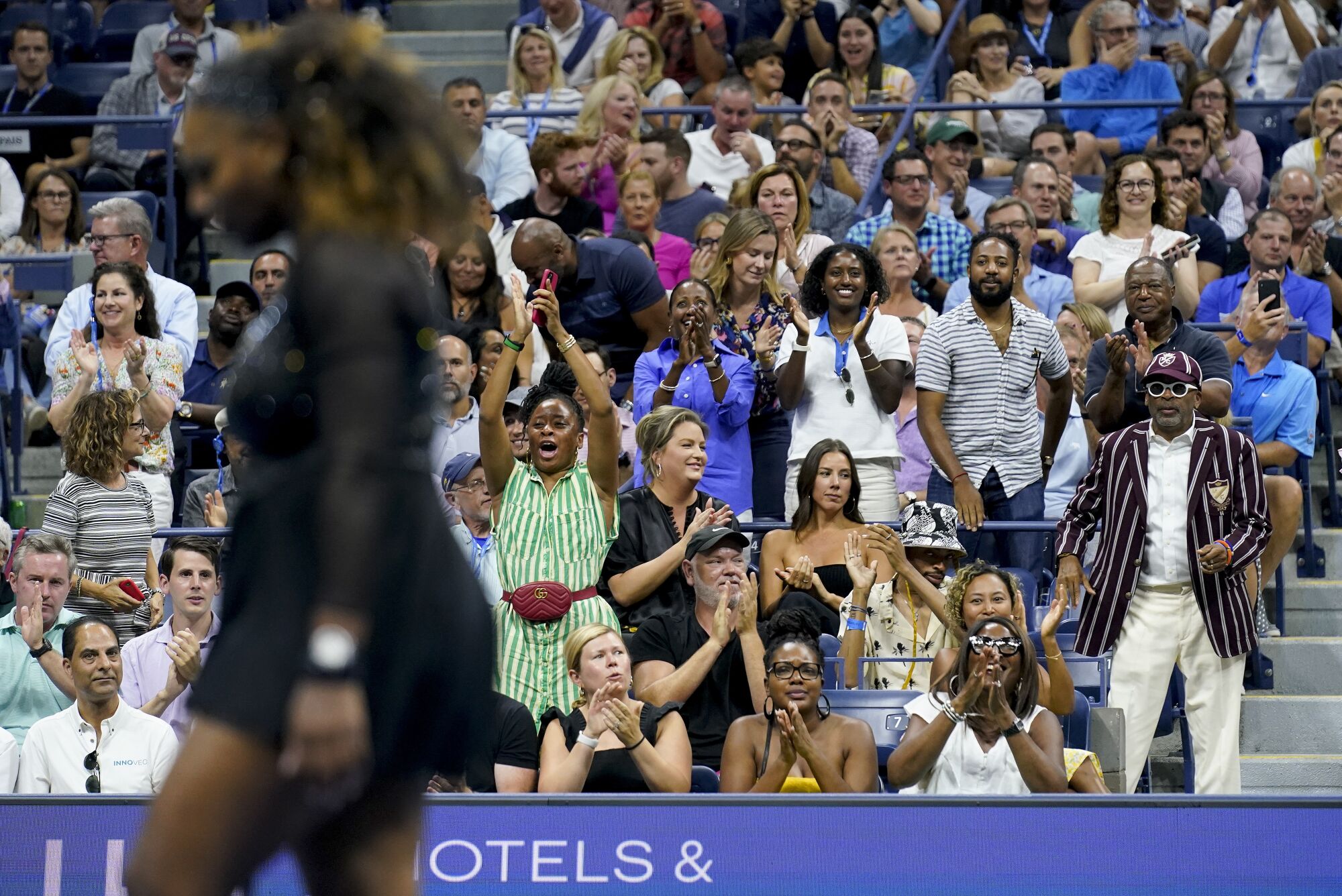 Spike Lee and fans cheer on Serena Williams as she plays Anett Kontaveit during the second round of the U.S. Open.