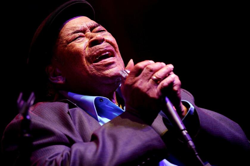 Grammy-winning blues legend James Cotton performs with his harmonica in 2014 at the W.C. Handy Blues and Barbecue Festival in Henderson, Ky.