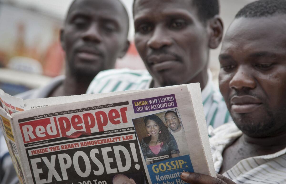 Ugandans read a copy of the Red Pepper newspaper in Kampala on Tuesday. It published a list of what it called the country's "200 top" homosexuals, outing some Ugandans who previously had not identified themselves as gay, one day after President Yoweri Museveni enacted a harsh anti-gay law.