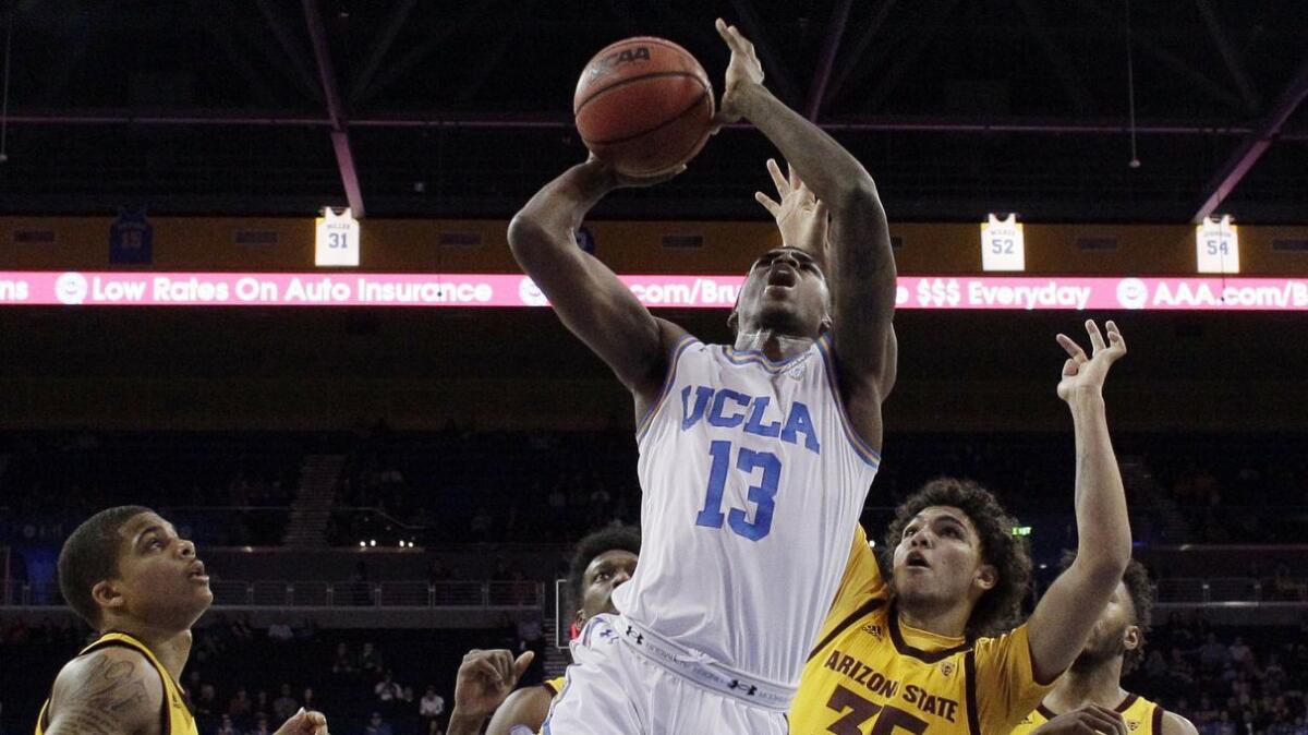 UCLA guard Kris Wilkes drives past Arizona State's Taeshon Cherry during a game on Jan. 24.