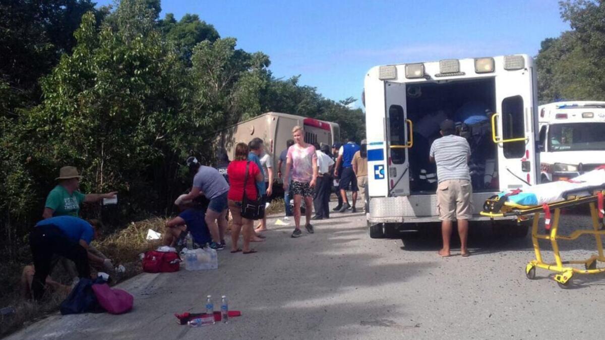 People receive medical attention after a bus crash on the Chetumal-Mahahual highway, in southern Mexico on Tuesday.