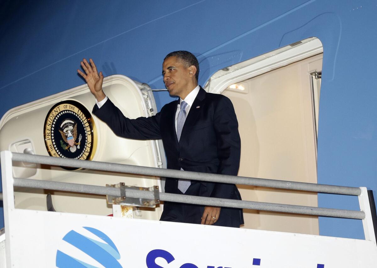President Barack Obama waves during his arrival on Air Force One at Los Angeles International Airport, Monday.
