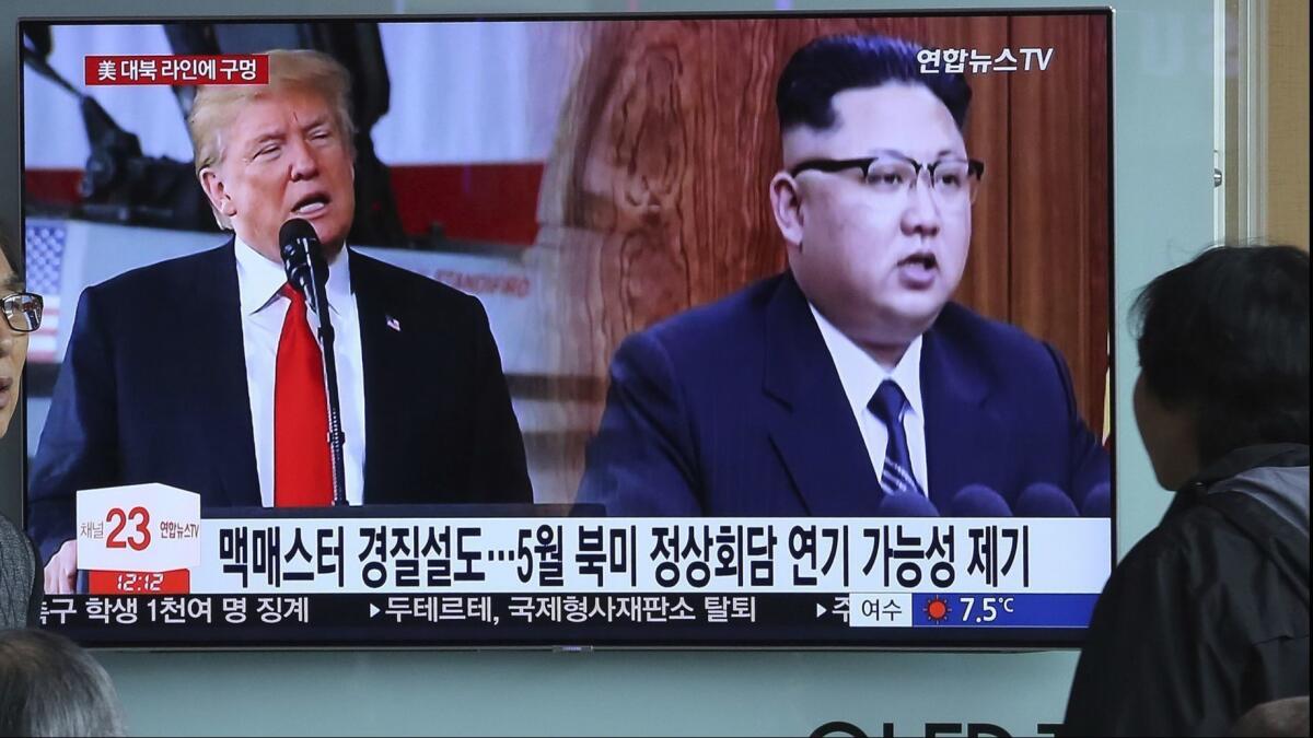 President Trump and North Korean leader Kim Jong Un on a TV monitor at the Seoul Railway Station on March 17. Trump and Moon, are both planning to meet Kim this spring.