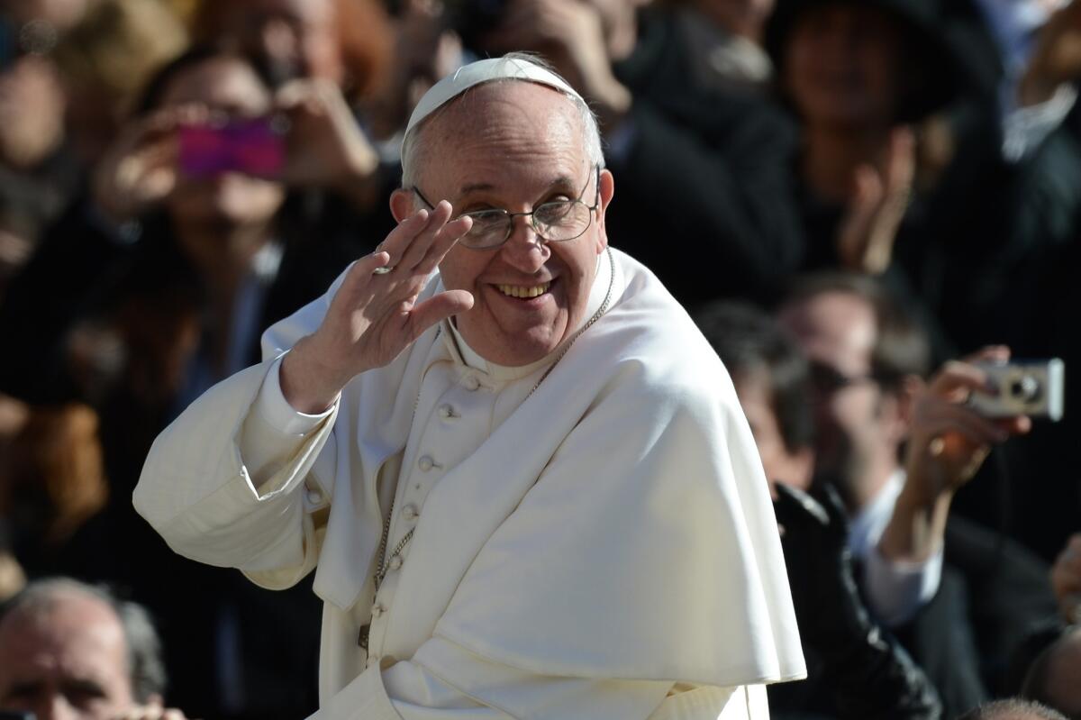 Pope Francis is seen waving to the crowd during his inauguration Mass at St. Peter's Square.