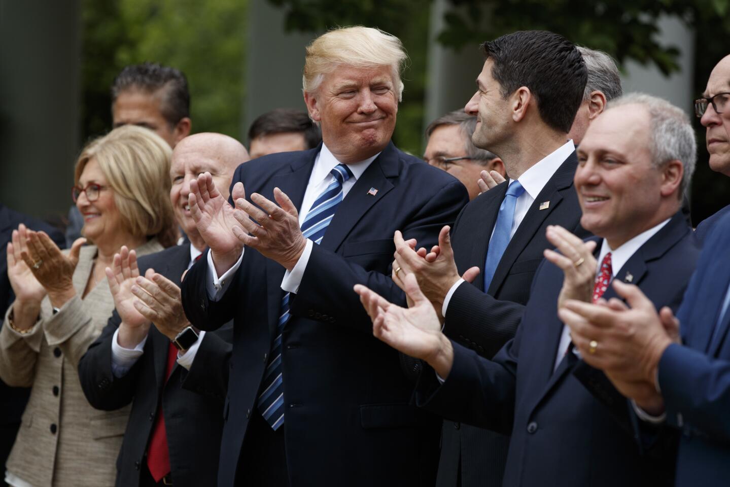 President Donald Trump smiles at Rep. Paul Ryan, R-Wis., in the Rose Garden of the White House after the House pushed through a health care bill on May 4, 2017, in Washington.