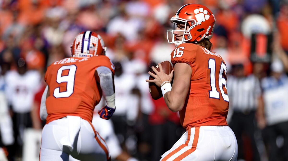 Clemson quarterback Trevor Lawrence drops back to pass during the first half against Louisville on Saturday. Clemson won 77-16.