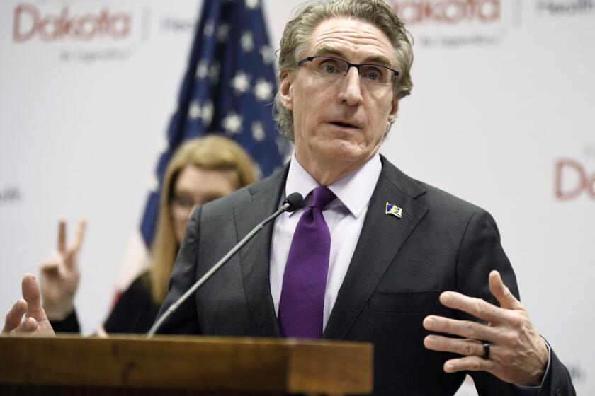FILE - In this April 10, 2020, file photo, North Dakota Gov. Doug Burgum speaks at the state Capitol in Bismarck, N.D. Hospitalizations from COVID-19 have hit their highest points recently throughout the Midwest, where the growth in new cases has been the worst in the nation. Doug Burgum, North Dakota's Republican governor, acknowledges his state's numbers are moving in the wrong direction as it hit new highs for active and newly confirmed cases, as well as hospitalizations. But he's also touting the state's test positivity staying in the 7% range.(Mike McCleary/The Bismarck Tribune via AP, File)