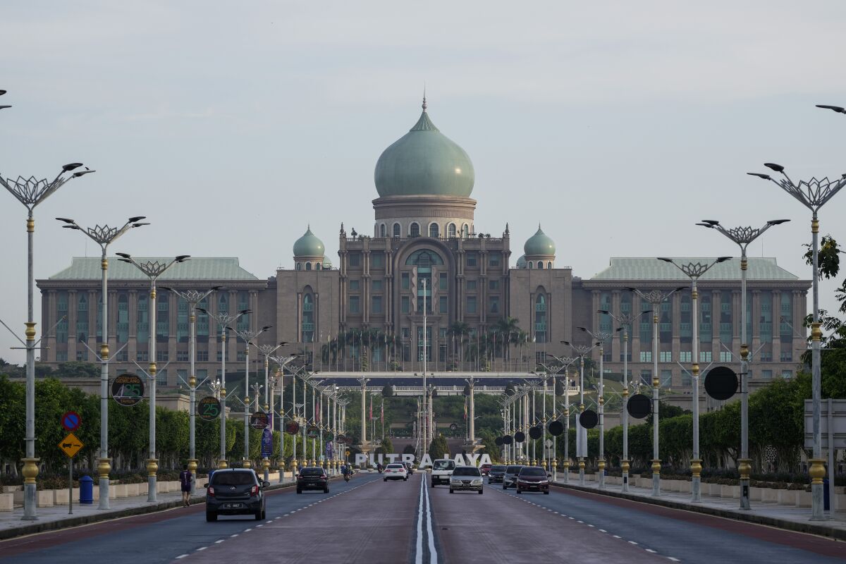 Morning traffic moves in front of the main building of the Malaysia Prime Minister's office is seen in Putrajaya, Malaysia, Wednesday, Dec. 8, 2021. Chinese hackers, likely state-sponsored, have been broadly targeting government and private-sector organizations across Southeast Asia, including Malaysia, according to a report released Wednesday by a U.S.-based private cybersecurity company. (AP Photo/Vincent Thian)